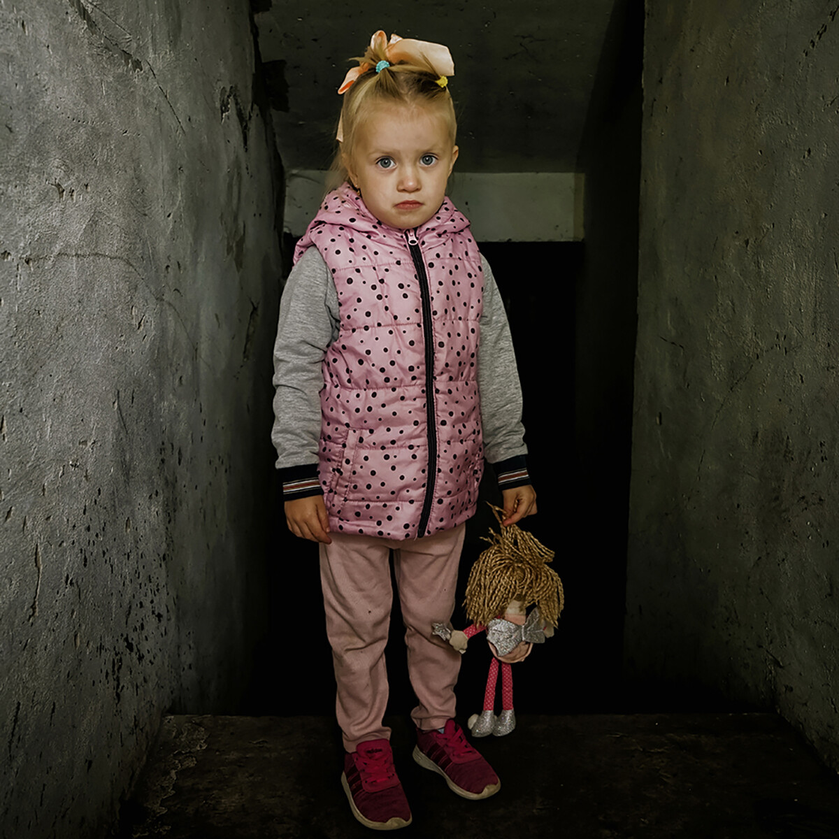 Die vierjährige Milana steht vor dem zerstörten Heizungsraum ihres Kindergartens.