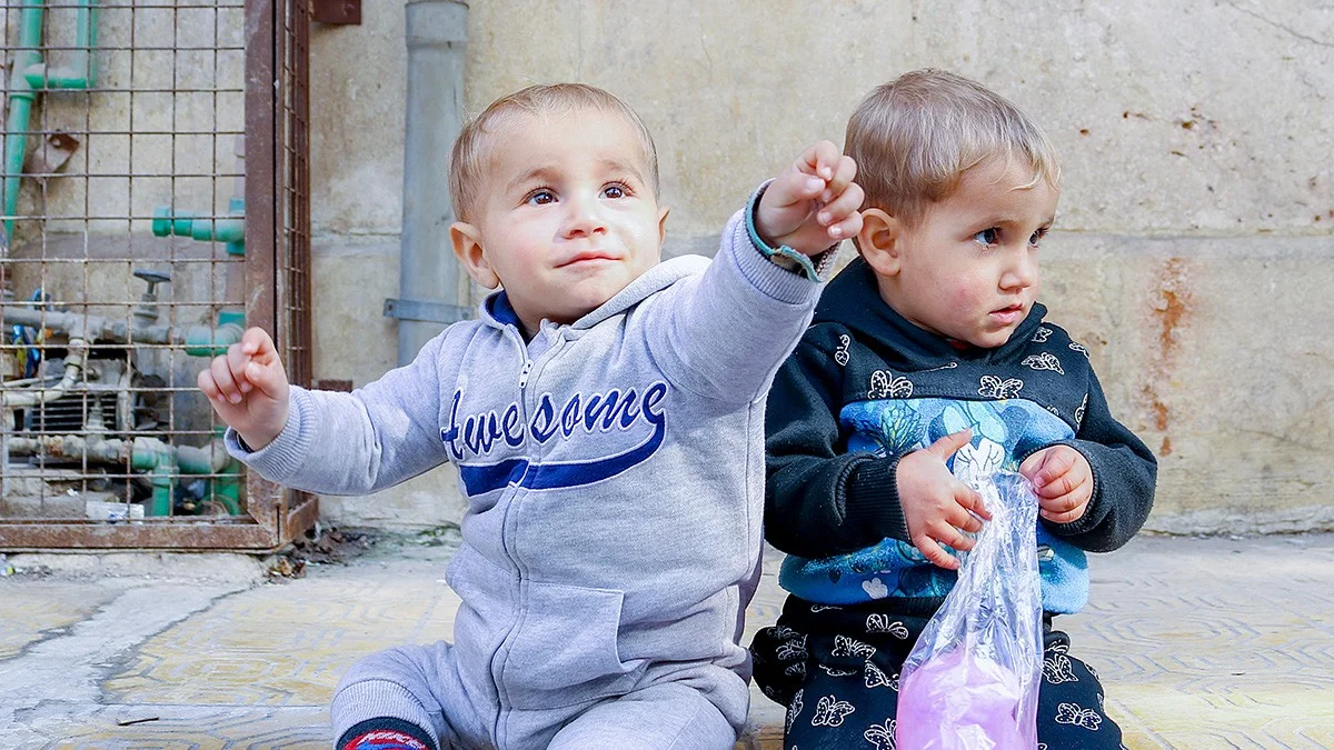 Two children sitting on the floor